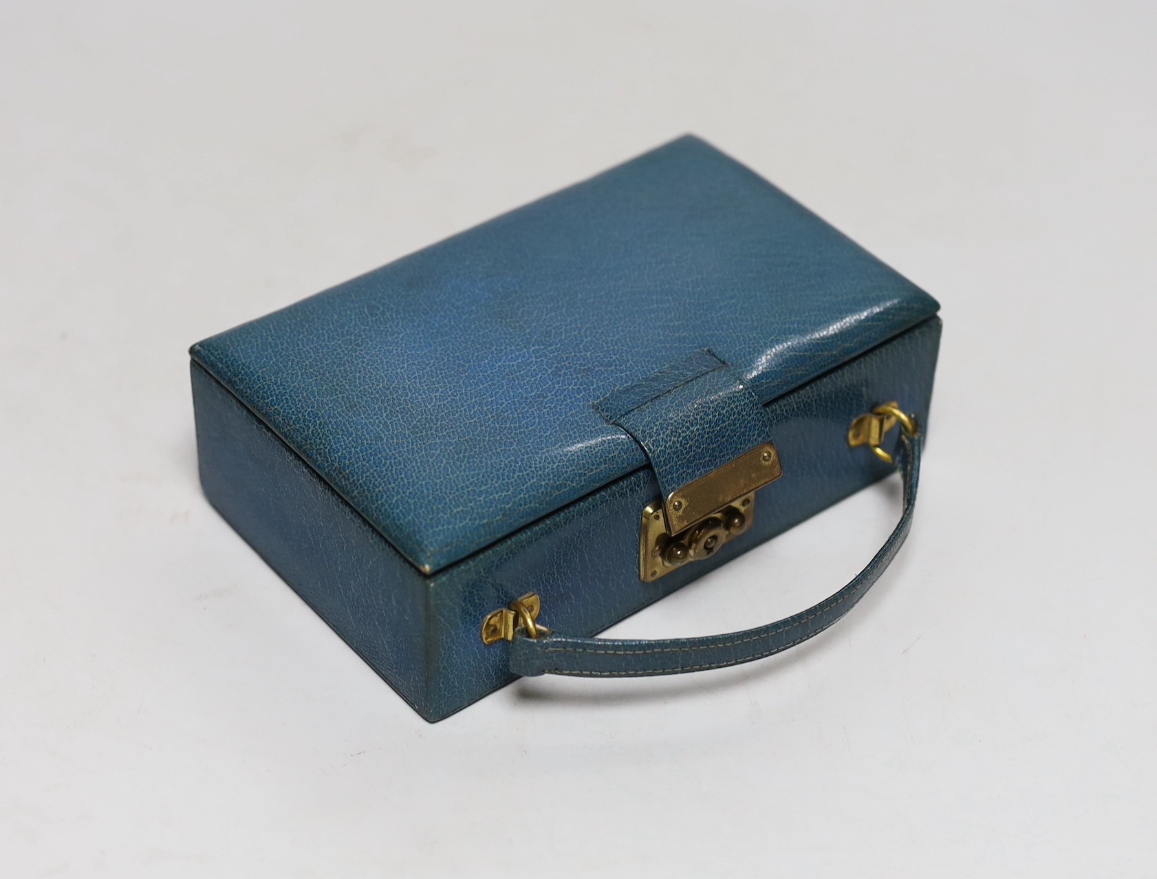 A lady's 1920's small leather vanity case, containing an enamelled comb, pill box and lipstick holder, the latter two with silver hallmarks, one for Cohen & Charles, London, 1926, the other with import marks only, case 1